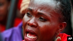 A woman attends a demonstration calling on the government to rescue the kidnapped Chibok school girls, outside the defense headquarters in Abuja, Nigeria, May 6, 2014. 