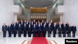 Syria's President Bashar al-Assad (front C) poses with members of his new cabinet in Damascus, Aug. 31, 2014.