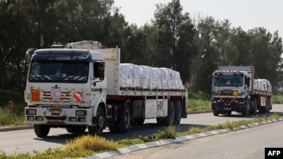 FILE - Trucks carrying humanitarian aid cargo arrive from Egypt on the Israeli side of the Kerem Shalom border crossing, to undergo security before entering the southern Gaza Strip, on January 10, 2024.