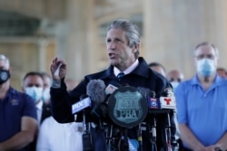 Surrounded by law enforcement and supporters, New York City PBA President Pat Lynch speaks during a news conference in New York, June 9, 2020. Lynch said the mayor and police leaders were "sacrificing cops to save their own skin."