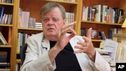 FILE - Garrison Keillor talks at his office in St. Paul, Minn., July 26, 2017.