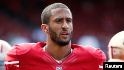 FILE - San Francisco 49ers quarterback Colin Kaepernick stands on the field before their NFL pre-season football game against the Denver Broncos in San Francisco, California, Aug. 8, 2013. 