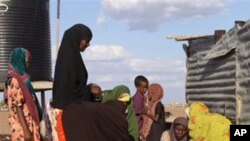 Women fetch water at the site of a borehole in Dertu, Kenya. The microbes that cause diarrhea spread through contaminated food and water, or through poor hygiene and sanitation.