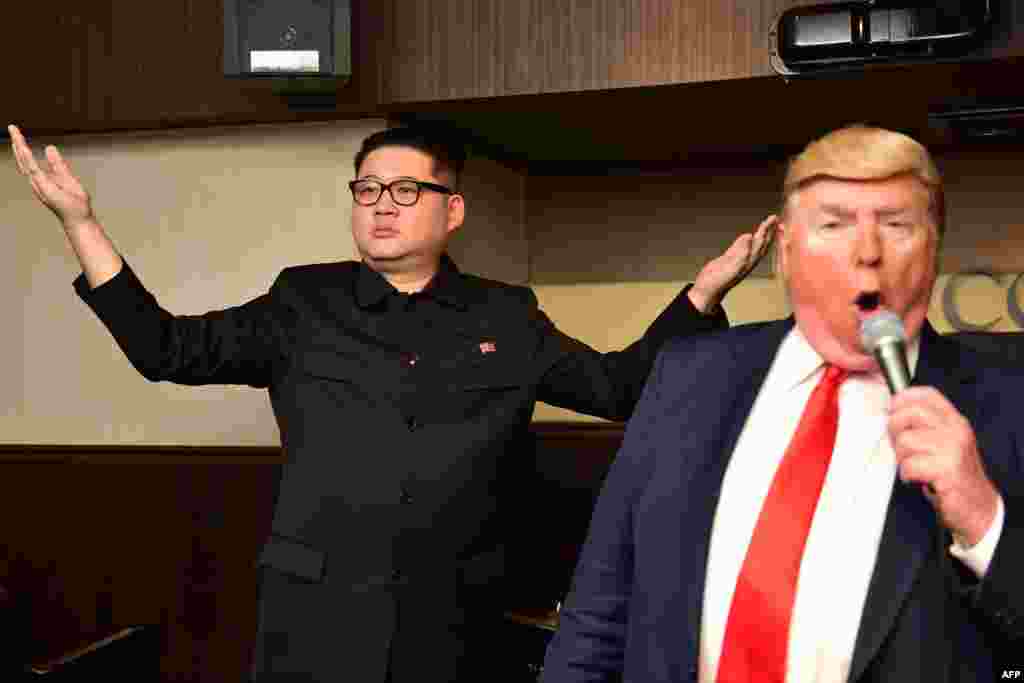 Impersonators of North Korean leader Kim Jong Un (L) and U.S. President Donald Trump perform at a bar in Osaka, Japan, ahead of the G-20 summit.