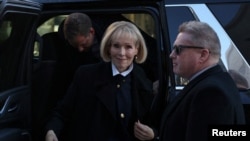 FILE - E. Jean Carroll enters Manhattan Federal Court on Jan. 22, 2024, in New York. The trial in her defamation case against former U.S. President Donald Trump was postponed for a second time and will resume on Jan. 25.