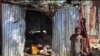 A child stands in front of a makeshift home in the Ma Drapo camp. (Matiado Vilme/VOA Creole) 