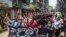 Anti-coup protesters hold a banner that reads "What are these? We are Yangon residents!" as they march during a demonstration in Yangon, Myanmar, April 27, 2021. 
