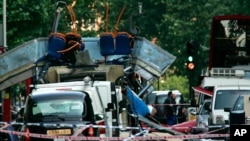 FILE - A double-decker bus blown up by a bomb and damaged cars are scattered at Tavistock Square in London, July 7, 2005. A mixture of homegrown extremists, geography and weak counterterrorism strategies have made Europe a prime target for jihadists.