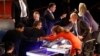 Bobby Jindal, left, Chris Christie, Mike Huckabee and Rick Santorum talk to moderators Trish Regan, Gerald Seib and Sandra Smith, right, after a Republican presidential debate at Milwaukee Theatre, Tuesday, Nov. 10, 2015, in Milwaukee.