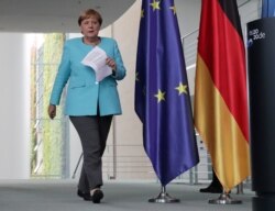 German Chancellor Angela Merkel arrives for a press conference at the Chancellery in Berlin, Germany, Aug. 19, 2020 following a video meeting of the european council.