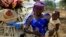 FILE - A United Nations report predicts a baby boom in Africa. Here, a woman carries her child in Nigeria's Kaduna State. 