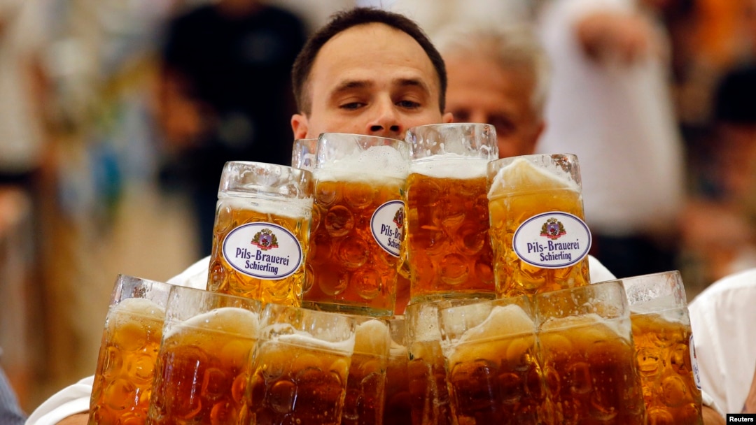 FILE - German Oliver Struempfl competes to set a new world record in carrying one liter beer mugs over a distance of 40 m (131 ft 3 in) in Abensberg, Sept. 7, 2014.