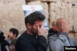 A man reacts as people take part in a mass prayer for the release of hostages kidnapped in the October 7 attack by Hamas, at the Western Wall, Judaism's holiest prayer site, in Jerusalem on March 21, 2024.