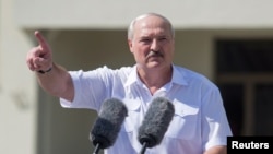 FILE - Belarusian President Alexander Lukashenko gestures as he delivers a speech during a rally of his supporters in Independence Square in Minsk, Belarus, Aug. 16, 2020. 