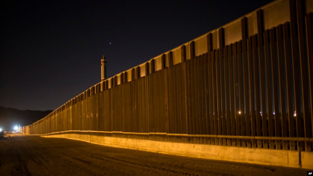FILE - A portion of the new steel border fence stretches along the U.S.-Mexico border in Sunland Park, New Mexico, March 30, 2017.