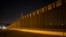 FILE - A portion of the new steel border fence stretches along the U.S.-Mexico border in Sunland Park, New Mexico, March 30, 2017.