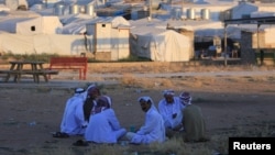 Displaced Iraqi men from the minority Yazidi sect, who fled the Iraqi town of Sinjar, are seen at the Khanki camp on the outskirts of Dohuk province, July 31, 2019.