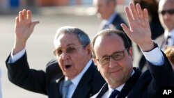 France's President Francois Hollande, right, and Cuba's President Raul Castro wave to reporters during Hollande's farewell ceremony at Jose Marti International Airport in Havana, May 12, 2015.