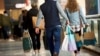FILE PHOTO: Shoppers carry bags of purchased merchandise at the King of Prussia Mall, United States' largest retail shopping space, in King of Prussia