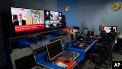 FILE - Al Jazeera broadcast engineer Mohammad Salameh works at the Master Control Room unit inside the network's office in the West Bank city of Ramallah, May 5, 2024. 