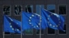 FILE - European Union flags flutter outside the European Commission headquarters in Brussels, Belgium, June 25, 2020. 