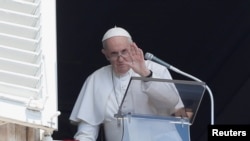 FILE - Pope Francis waves as he leaves after leading Angelus prayer from his window at the Vatican following intestinal surgery, at the Vatican, July 18, 2021.