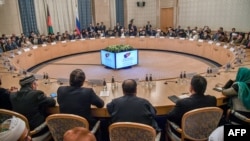 FILE - Participants attend talks between the Taliban and Afghan opposition representatives at the President Hotel, in Moscow, Russia, Feb. 5, 2019. 