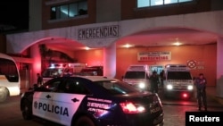 A police patrol car is seen outside a hospital where injured inmates were taken following a shootout among inmates at La Joyita prison, in Panama City, Panama, Dec. 17, 2019.
