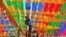 A South Korean worker attaches name cards with wishes of Buddhist followers to lotus lanterns ahead of the Buddha's birthday at Jogye temple in Seoul on May 13, 2016.