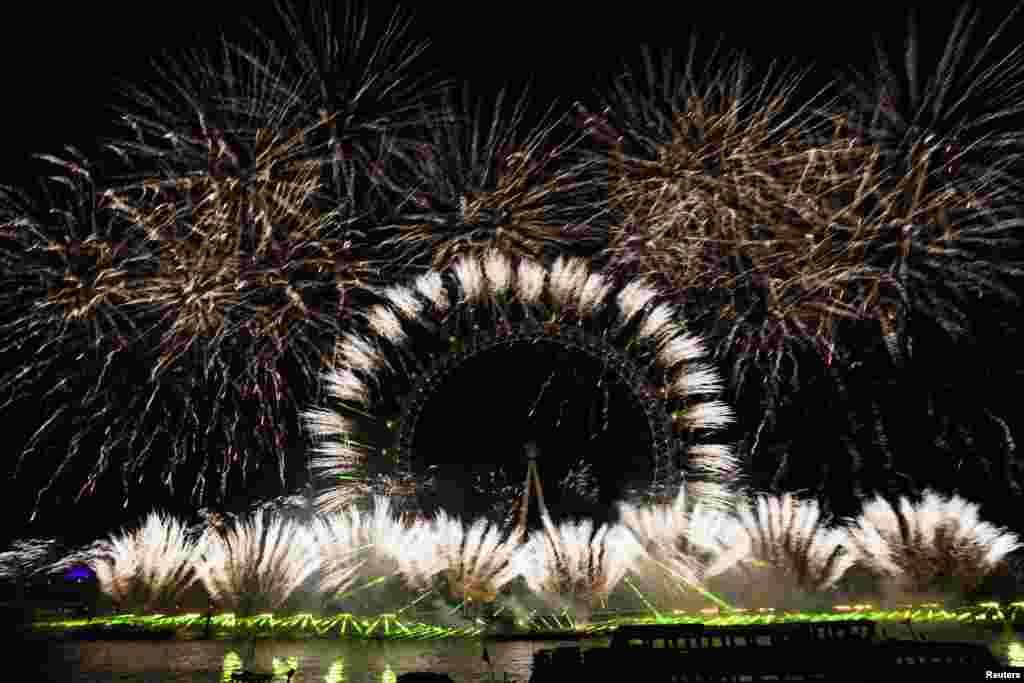 Fireworks explode over the London Eye Ferris wheel as Britons across the country welcome the New Year, in London.