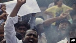 Indian students demanding the creation of a new Telangana state shout slogans as they burn an effigy of the government during a protest in Hyderabad, India, Tuesday, Feb.22, 2011. (AP Photo/Mahesh Kumar A.)