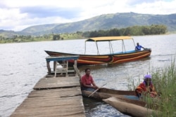 An elderly woman and her daughter leave the Bwama Health Centre III, at Bwama Island – Lake Bunyonyi, in Western Uganda, Apr. 28, 2021, after receiving her COVID-19 vaccination.