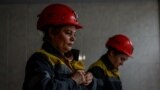 Nataliia, 43-years-old, and Krystyna, 22-years-old, dress in uniforms before going down to work their shift underground, amid Russia's attack on Ukraine, at a mine in Dnipropetrovsk region, Ukraine on November 17, 2023. (REUTERS/Alina Smutko)