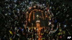 People light candles during a vigil in honor of Nicolas Guerrero who died after being shot during a national strike against tax reform in Cali, Colombia, May 3, 2021. Guerrero was shot during clashes with police on Sunday.