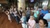 Passengers from the cruise ship Westerdam watch Cambodian dancers perform at a hotel in Phnom Penh, Cambodia, Wednesday, Feb. 19, 2020. (AP Photo/Heng Sinith)