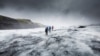 People hike in a glacier