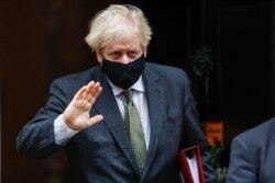 Britain's Prime Minister Boris Johnson gestures as he leaves Downing Street in London, Britain, Dec. 9, 2020.