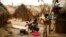 FILE - Families living in a refugee camp prepare food in Kaga-Bandoro, Central African Republic, Tuesday Feb. 16,  2016.  