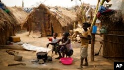 FILE - Families living in a refugee camp prepare food in Kaga-Bandoro, Central African Republic, Feb. 16, 2016. Nearly half of the country's population of 4.6 million is in need of humanitarian assistance.