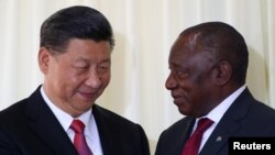 FILE - China's President Xi Jinping talks with South African President Cyril Ramaphosa after their media conference in Pretoria, South Africa, July 24, 2018. 