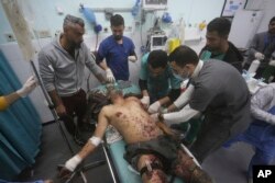 A Palestinian man wounded in the Israeli bombardment of the Gaza Strip is treated in a hospital in Rafah, on Dec. 30, 2023.