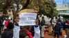 Demonstrators gather in support of activists detained in mid-June 2024, outside the Harare Magistrates Court.
