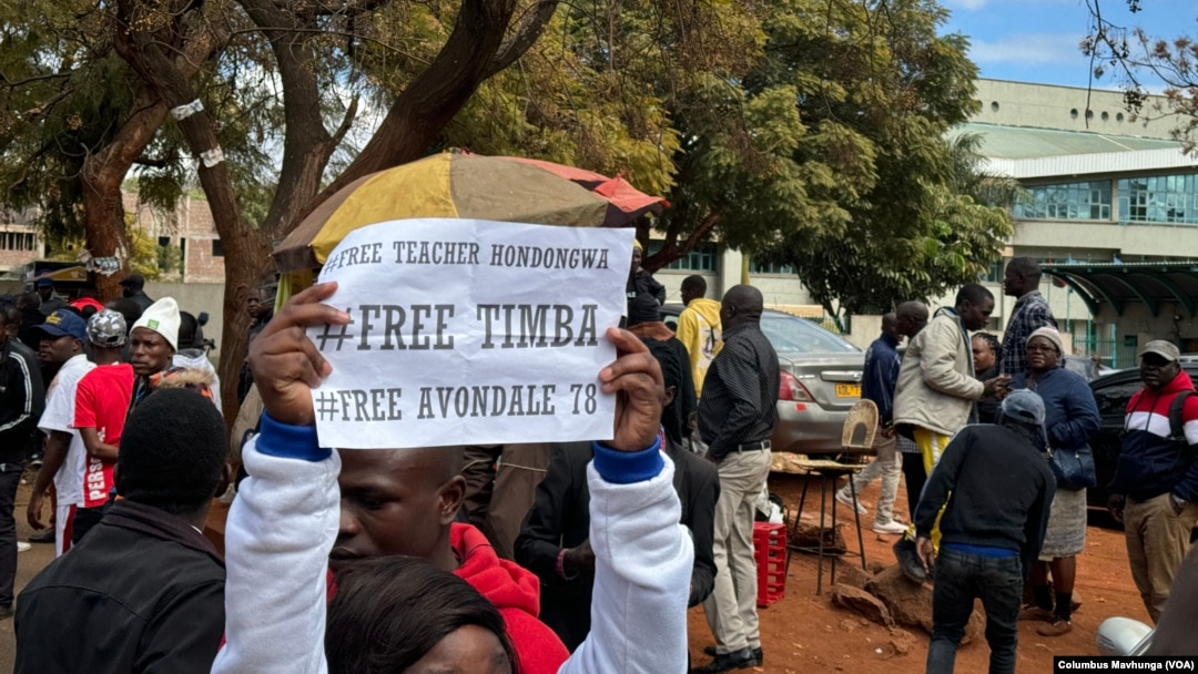 Demonstrators gather in support of activists detained in mid-June 2024, outside the Harare Magistrates Court.
