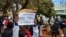 Demonstrators gather in support of activists detained in mid-June 2024, outside the Harare Magistrates Court.
