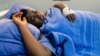 FILE - Activist Joana Mamombe lies hospitalized in Harare on May 15, 2020. after allegedly being abducted and beaten by police and eventually dumped along the roadside some distance from the capital.