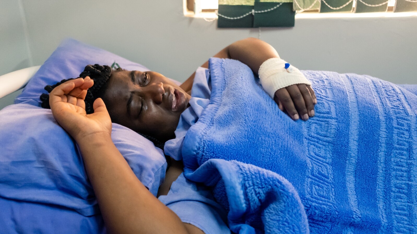 FILE - Zimbabwean activist Joana Mamombe lies hospitalized in Harare on May 15, 2020, after allegedly being abducted and beaten by police and eventually dumped along a road some distance from the capital.
