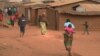 FILE - Refugees of various nationalities walk through Dzaleka refugee camp, Dowa district, in Malawi's Central region, June 20, 2018.