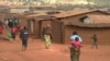 FILE - Refugees of various nationalities walk through Dzaleka refugee camp, Dowa district, in Malawi's Central region, June 20, 2018.