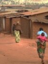 FILE - Refugees of various nationalities walk through the Dzaleka refugee camp, Dowa district, in Malawi's central region, June 20, 2018.