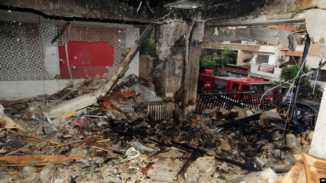 FILE - In this photo released by the Syrian official news agency SANA, a damaged building targeted by Israeli missile strikes is seen in the early morning in the Mezzeh area in the capital Damascus, Syria, Nov. 12, 2019. 